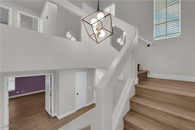 638 Ribbon Grass Ave, Las Vegas, NV 89183 - stairway with a chandelier and wood finished floors