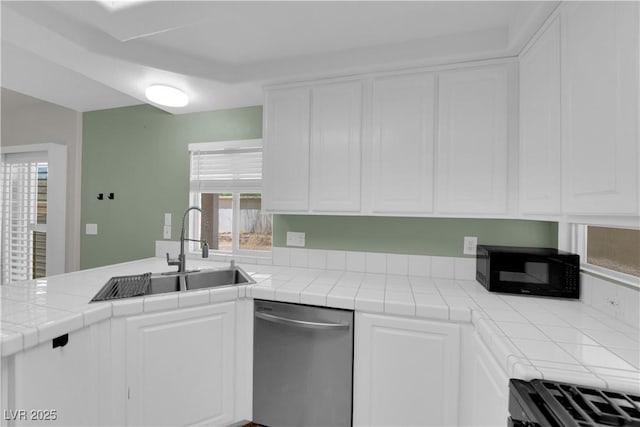 638 Ribbon Grass Ave, Las Vegas, NV 89183 - kitchen with black appliances, white cabinets, tile counters, and a peninsula