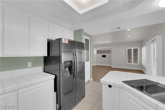 638 Ribbon Grass Ave, Las Vegas, NV 89183 - kitchen with stainless steel fridge, tile countertops, white cabinetry, and recessed lighting