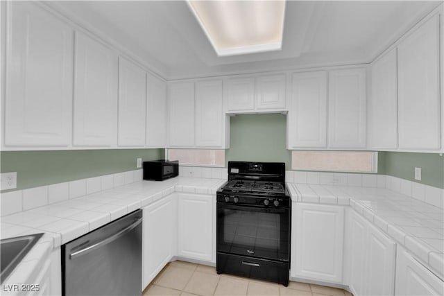 638 Ribbon Grass Ave, Las Vegas, NV 89183 - kitchen featuring black appliances, tile countertops, white cabinets, and light tile patterned flooring