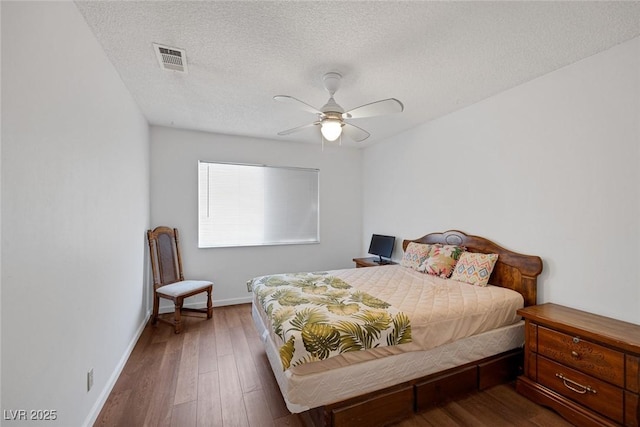 4458 El Quinta Ct, Las Vegas, NV 89121 - bedroom with a textured ceiling, wood finished floors, and ceiling fan