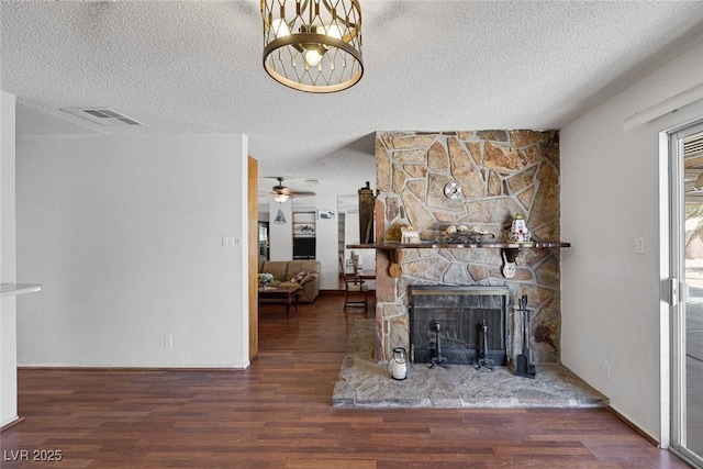 4458 El Quinta Ct, Las Vegas, NV 89121 - living room with a fireplace, a textured ceiling, wood finished floors, and a ceiling fan