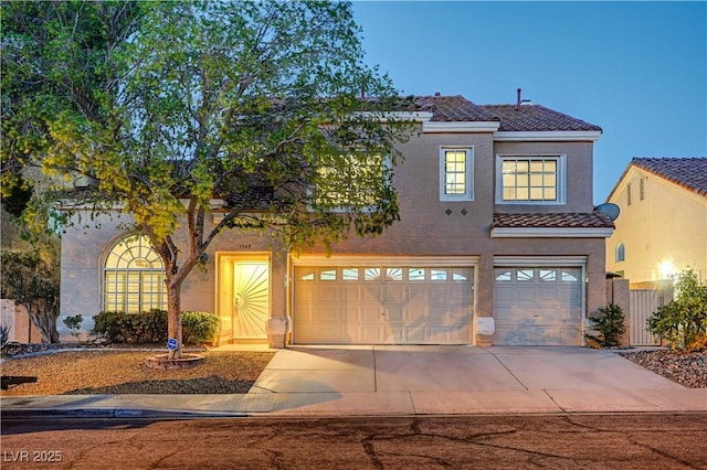 1968 Evening Glow Dr, Las Vegas, NV 89134 - mediterranean / spanish house featuring a tiled roof, an attached garage, driveway, and stucco siding