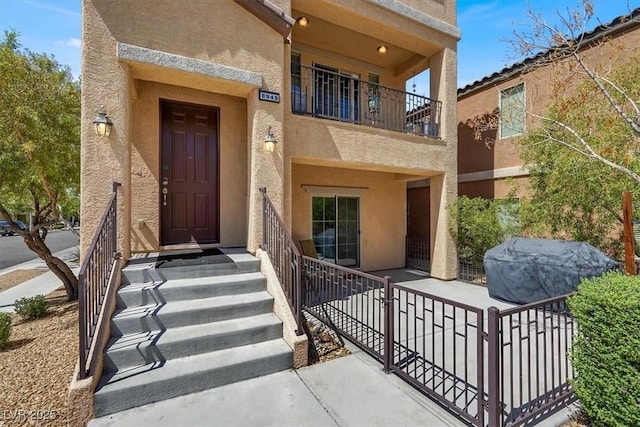 8949 Merry Mullion Ct, Las Vegas, NV 89149 - view of exterior entry featuring stucco siding and a balcony