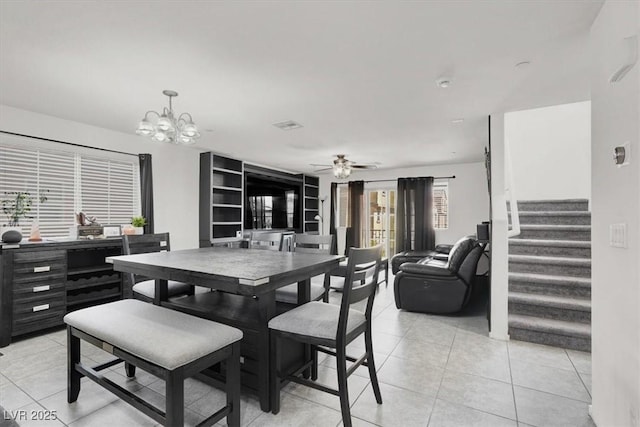 8949 Merry Mullion Ct, Las Vegas, NV 89149 - dining room featuring a chandelier, light tile patterned floors, stairs, and a ceiling fan