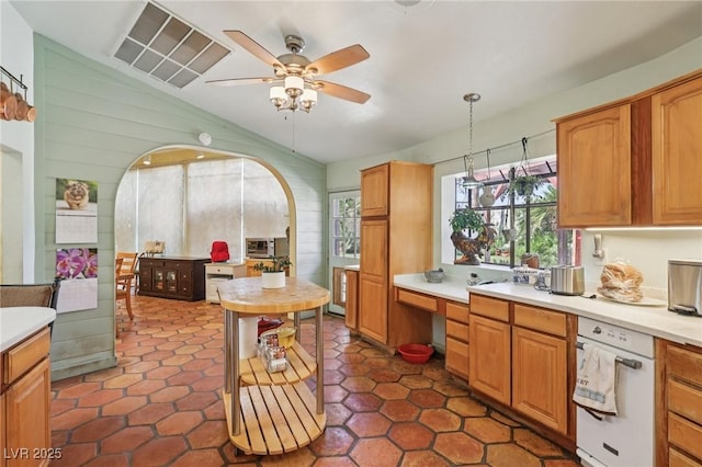 55 Siddall Ave, Las Vegas, NV 89183 - kitchen with lofted ceiling, arched walkways, light countertops, a ceiling fan, and pendant lighting
