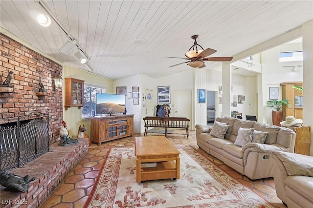 55 Siddall Ave, Las Vegas, NV 89183 - living area with ceiling fan, vaulted ceiling, a brick fireplace, wood ceiling, and light tile patterned floors