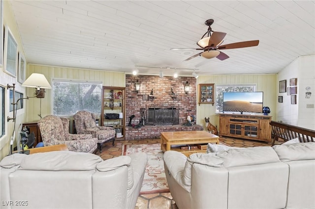 55 Siddall Ave, Las Vegas, NV 89183 - living room with track lighting, ceiling fan, wooden walls, a fireplace, and wooden ceiling