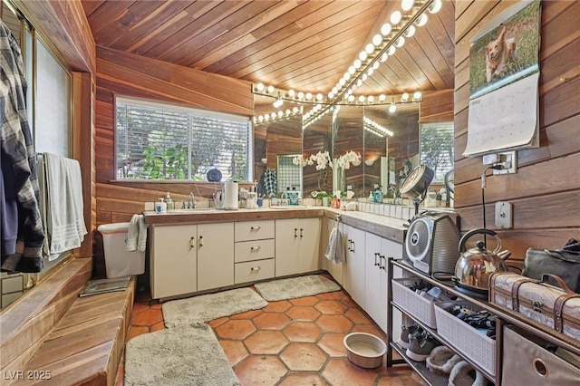 55 Siddall Ave, Las Vegas, NV 89183 - kitchen featuring wood walls, plenty of natural light, light countertops, wood ceiling, and white cabinetry