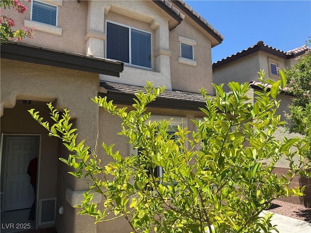 248 Crystal Rose Ct, Las Vegas, NV 89106 - view of home's exterior with stucco siding and a tile roof