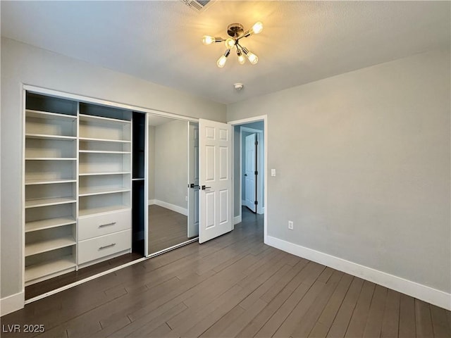 248 Crystal Rose Ct, Las Vegas, NV 89106 - unfurnished bedroom featuring dark wood-style floors, a closet, and a chandelier