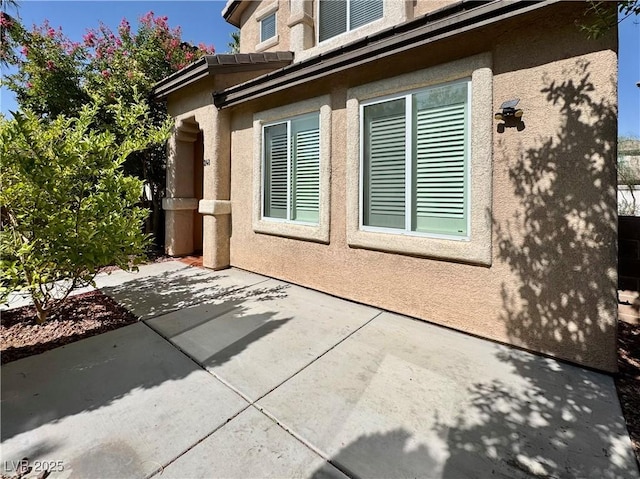 248 Crystal Rose Ct, Las Vegas, NV 89106 - view of property exterior featuring stucco siding and a patio