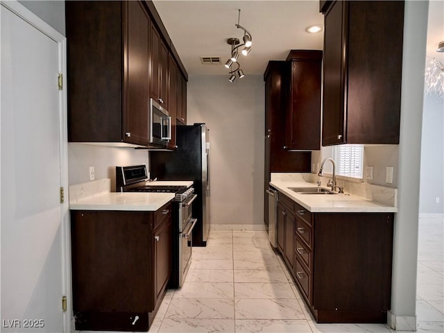 248 Crystal Rose Ct, Las Vegas, NV 89106 - kitchen featuring appliances with stainless steel finishes, light marble finish floors, dark brown cabinetry, and light countertops