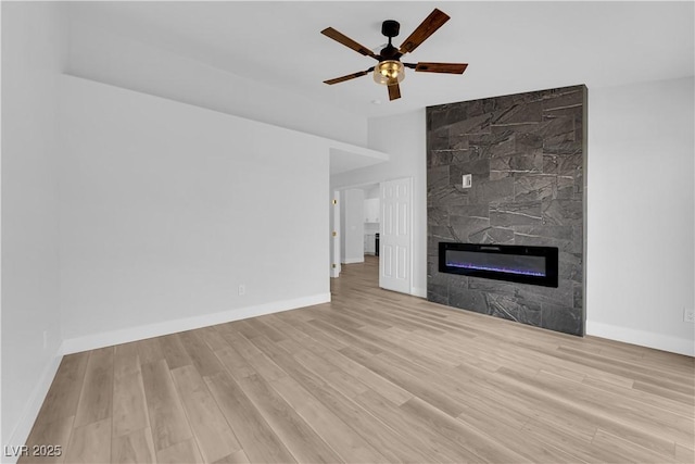 9412 Mount Cherie Ave Unit 102, Las Vegas, NV 89129 - unfurnished living room with ceiling fan, wood finished floors, and a fireplace