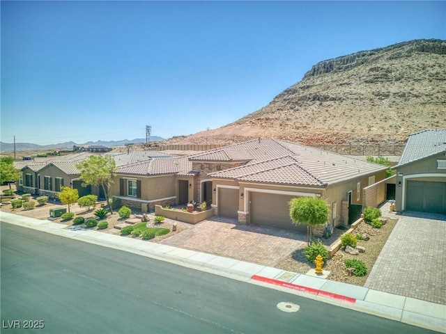 6315 Carol Butte Ct, Las Vegas, NV 89141 - view of front facade featuring a mountain view, stucco siding, a tile roof, a garage, and driveway