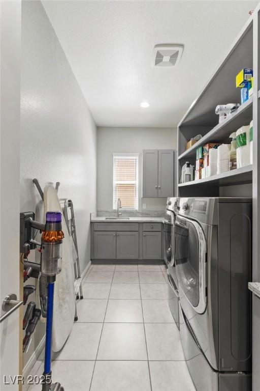 6315 Carol Butte Ct, Las Vegas, NV 89141 - laundry area featuring washer and clothes dryer, cabinet space, and light tile patterned floors