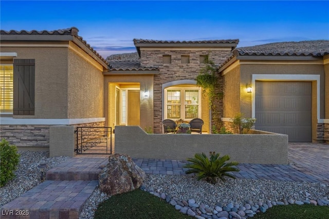 6315 Carol Butte Ct, Las Vegas, NV 89141 - view of front of house featuring a garage, stone siding, stucco siding, a fenced front yard, and a tile roof