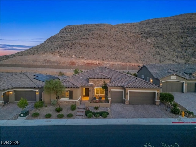 6315 Carol Butte Ct, Las Vegas, NV 89141 - view of front of property with a garage, a tile roof, stucco siding, and decorative driveway