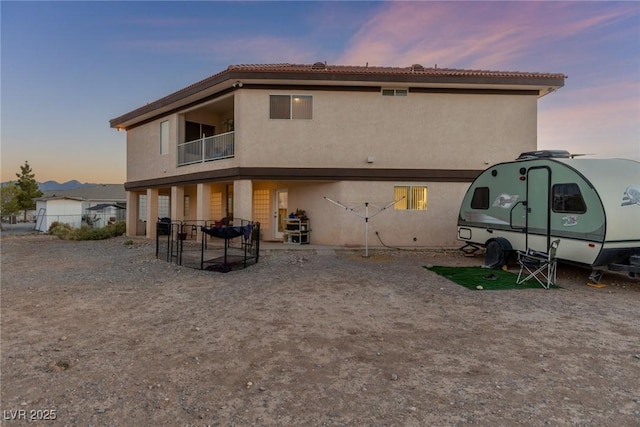 3821 Tumbleweed Ave, Pahrump, NV 89048 - back of property with a balcony and stucco siding