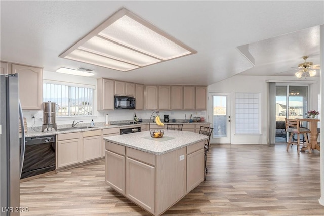 3821 Tumbleweed Ave, Pahrump, NV 89048 - kitchen featuring black appliances, light wood-style flooring, and a kitchen island