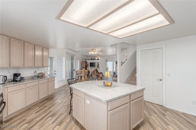 3821 Tumbleweed Ave, Pahrump, NV 89048 - kitchen with light wood finished floors, light countertops, a center island, a ceiling fan, and open floor plan