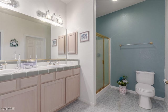 3821 Tumbleweed Ave, Pahrump, NV 89048 - bathroom featuring a shower stall, double vanity, and tile patterned floors