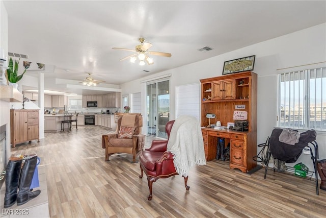 3821 Tumbleweed Ave, Pahrump, NV 89048 - living room featuring a ceiling fan, light wood-style floors, and a desk