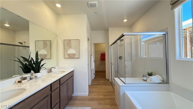 739 Wild Highlands Ln, Henderson, NV 89015 - full bath featuring a stall shower, wood finished floors, plenty of natural light, double vanity, and recessed lighting