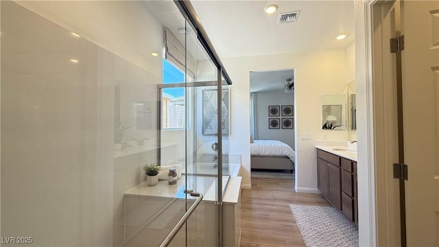 739 Wild Highlands Ln, Henderson, NV 89015 - full bath featuring vanity, ensuite bath, wood finished floors, a shower stall, and recessed lighting