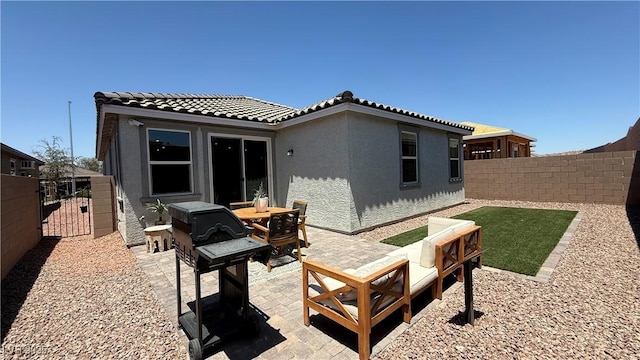 739 Wild Highlands Ln, Henderson, NV 89015 - back of property featuring a fenced backyard, stucco siding, a patio, and a tiled roof