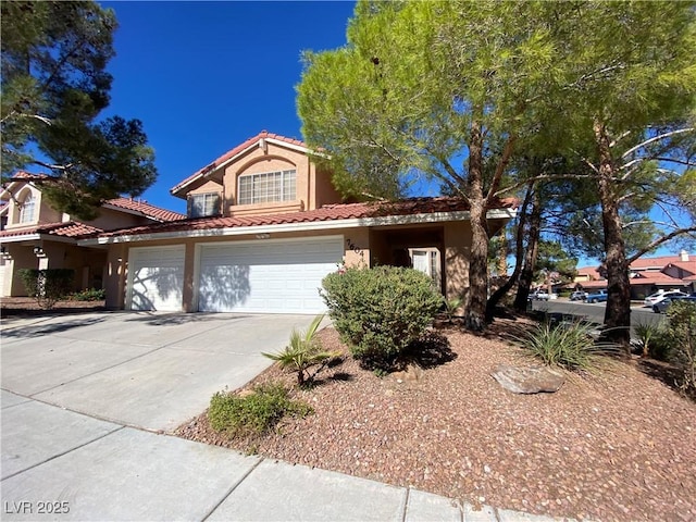 7604 Cruz Bay Ct, Las Vegas, NV 89128 - view of front facade featuring stucco siding, concrete driveway, a tiled roof, and an attached garage