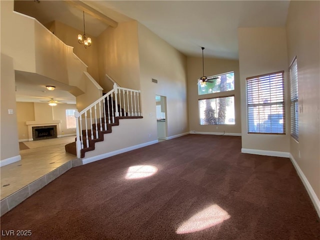 7604 Cruz Bay Ct, Las Vegas, NV 89128 - unfurnished living room with ceiling fan, stairs, carpet flooring, and high vaulted ceiling