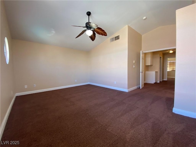 7604 Cruz Bay Ct, Las Vegas, NV 89128 - empty room featuring a ceiling fan, dark colored carpet, vaulted ceiling, and healthy amount of natural light