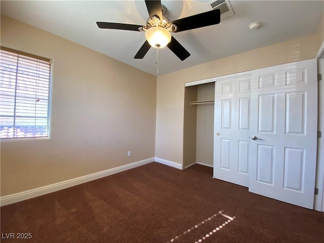 7604 Cruz Bay Ct, Las Vegas, NV 89128 - unfurnished bedroom with dark colored carpet, a closet, and a ceiling fan