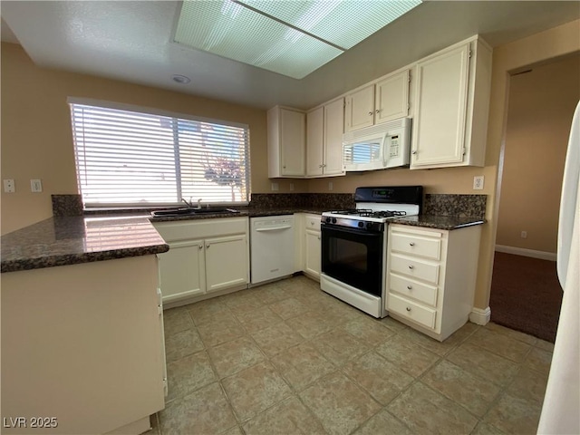 7604 Cruz Bay Ct, Las Vegas, NV 89128 - kitchen featuring white appliances, white cabinets, and dark stone countertops