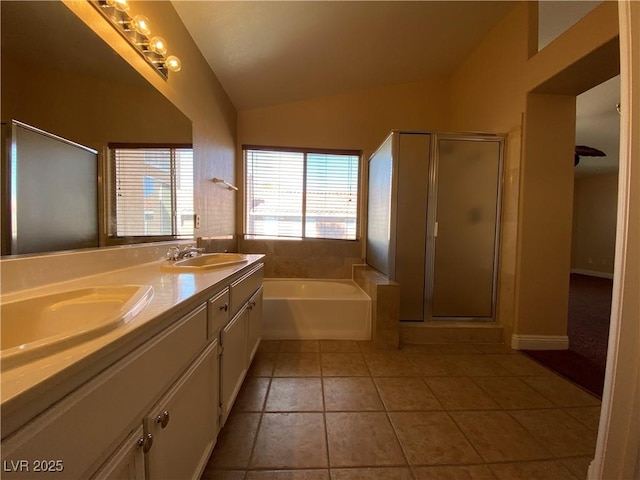 7604 Cruz Bay Ct, Las Vegas, NV 89128 - bathroom featuring vaulted ceiling, a bath, tile patterned floors, double vanity, and a stall shower