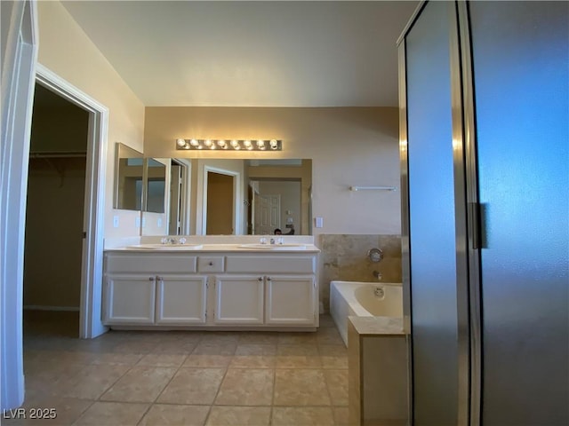 7604 Cruz Bay Ct, Las Vegas, NV 89128 - bathroom with double vanity, a garden tub, tile patterned floors, and a walk in closet
