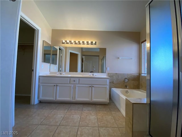 7604 Cruz Bay Ct, Las Vegas, NV 89128 - full bathroom with double vanity, a bath, and a walk in closet