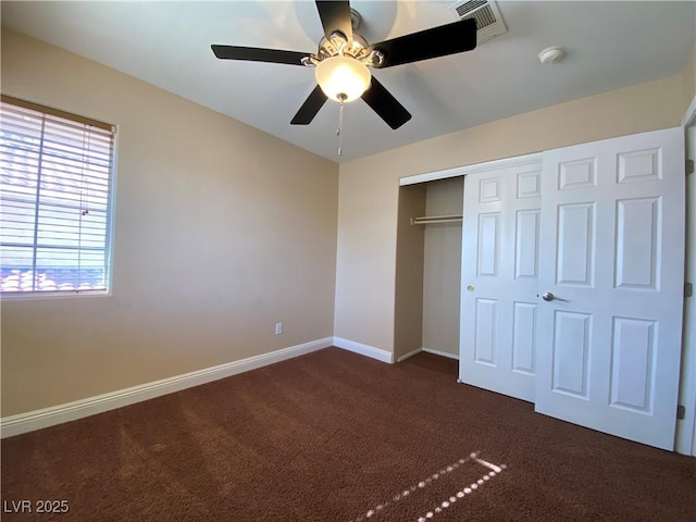 7604 Cruz Bay Ct, Las Vegas, NV 89128 - unfurnished bedroom with dark colored carpet, a closet, and a ceiling fan