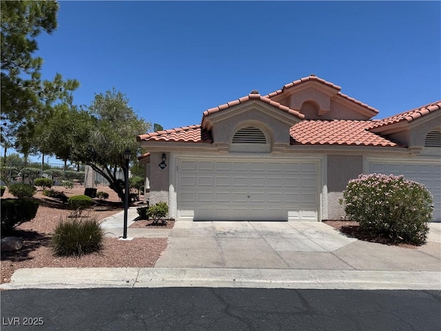 7830 Foxwood Pl Unit 0, Las Vegas, NV 89145 - mediterranean / spanish house featuring a garage, driveway, stucco siding, and a tile roof
