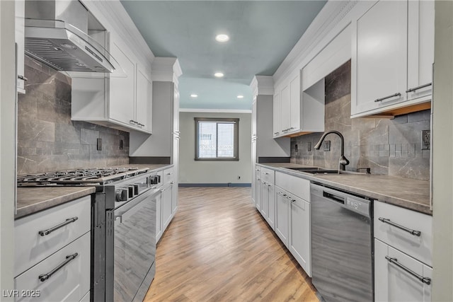 4272 Sheppard Dr, Las Vegas, NV 89121 - kitchen featuring stainless steel range with gas cooktop, dishwashing machine, wall chimney exhaust hood, decorative backsplash, and crown molding