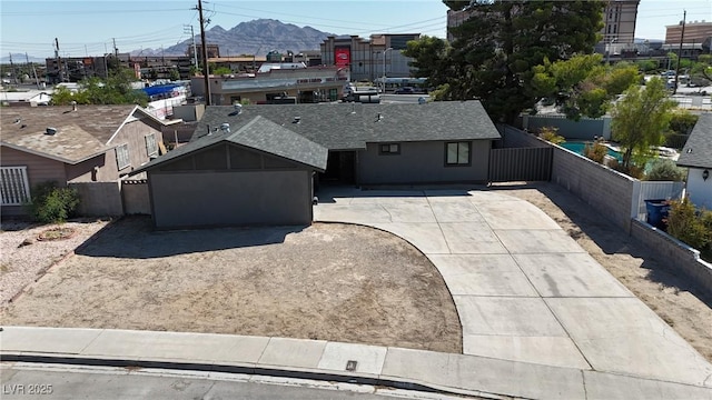 4272 Sheppard Dr, Las Vegas, NV 89121 - view of front of home with roof with shingles, driveway, and a mountain view