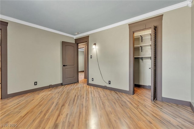 4272 Sheppard Dr, Las Vegas, NV 89121 - unfurnished bedroom with light wood-type flooring, ornamental molding, a walk in closet, and a closet