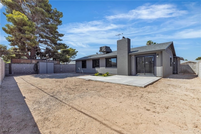 4272 Sheppard Dr, Las Vegas, NV 89121 - rear view of property with a chimney, a patio area, roof with shingles, a fenced backyard, and stucco siding