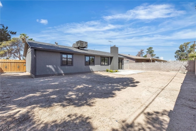 4272 Sheppard Dr, Las Vegas, NV 89121 - back of house featuring a fenced backyard, a patio, a shingled roof, and a chimney