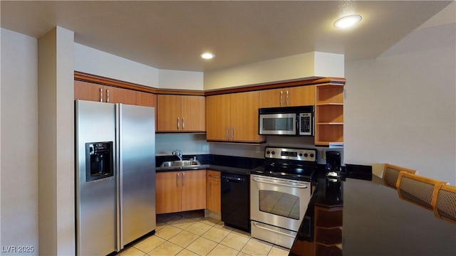 211 E Flamingo Rd Unit 202, Las Vegas, NV 89169 - kitchen with stainless steel appliances, dark countertops, open shelves, light tile patterned floors, and recessed lighting