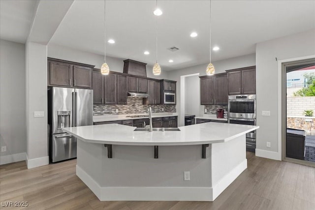 251 Castellari Dr, Las Vegas, NV 89138 - kitchen featuring stainless steel appliances, dark brown cabinets, backsplash, light countertops, and recessed lighting