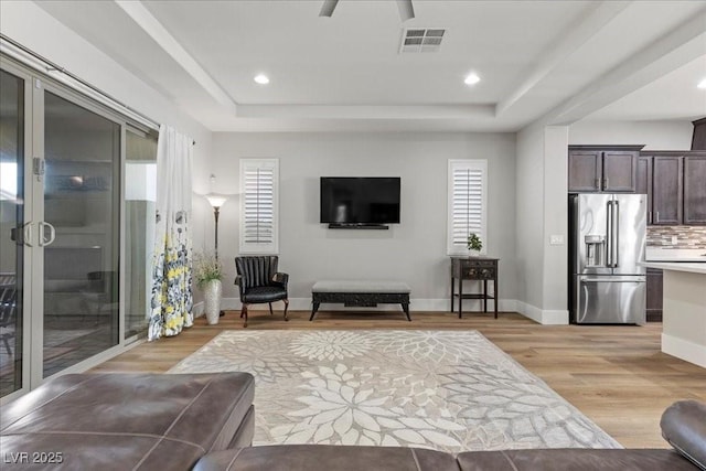 251 Castellari Dr, Las Vegas, NV 89138 - living area featuring a raised ceiling, light wood-type flooring, healthy amount of natural light, and recessed lighting