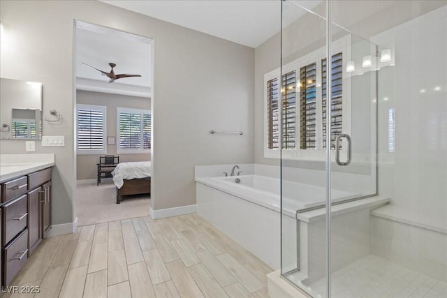 251 Castellari Dr, Las Vegas, NV 89138 - ensuite bathroom with vanity, a garden tub, a stall shower, and a ceiling fan