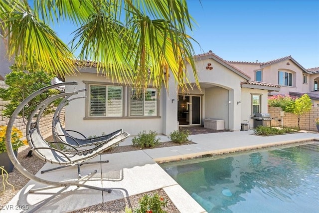 251 Castellari Dr, Las Vegas, NV 89138 - back of property with stucco siding, an outdoor pool, a tile roof, and a patio area